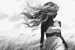 women walking in the grass smoking having her back shown and wind blowing her hair